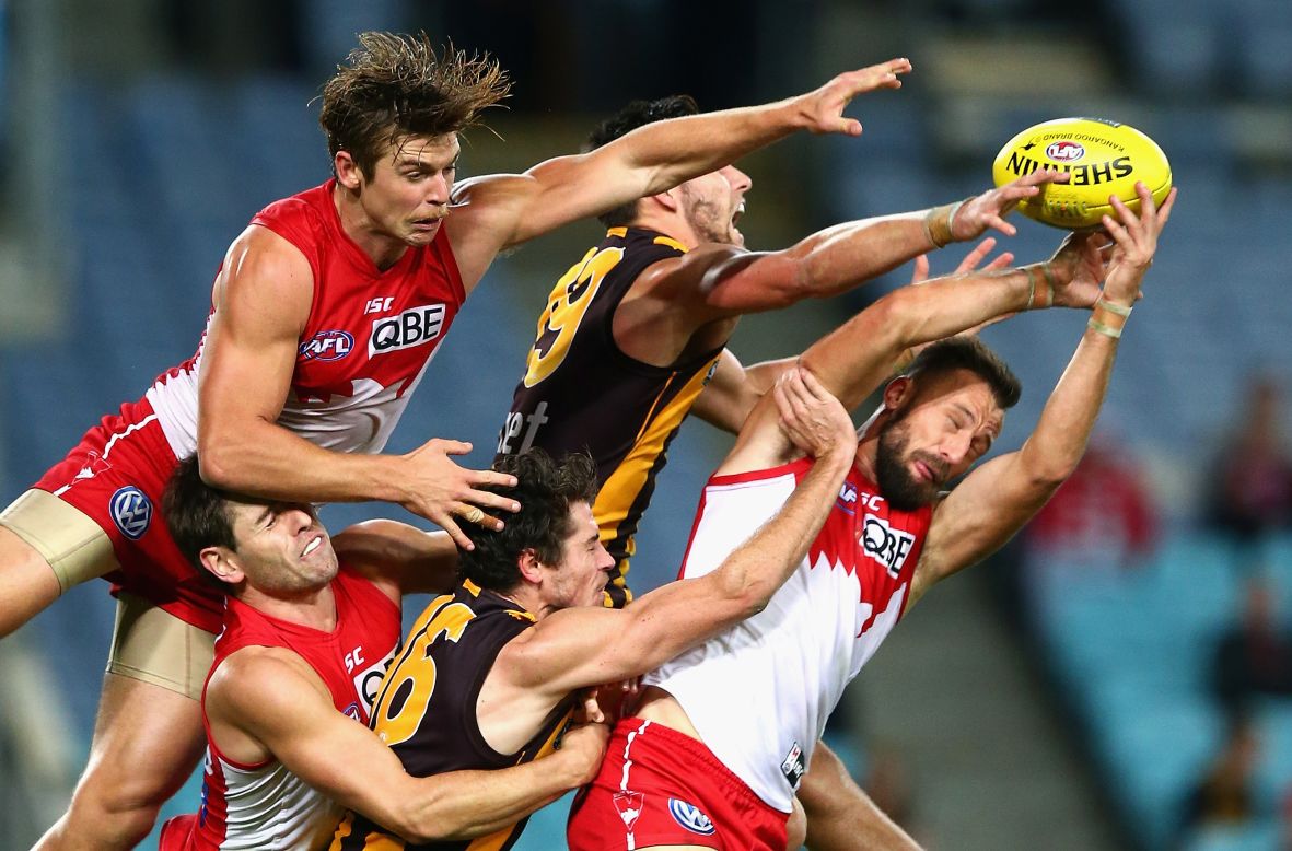 Nick Malceski and Dane Rampe of the Sydney Swans compete for the ball against Jack Gunston and Isaac Smith of the Hawthorn Hawks during an Australian Football League match in Sydney, Australia, on Friday, May 9.