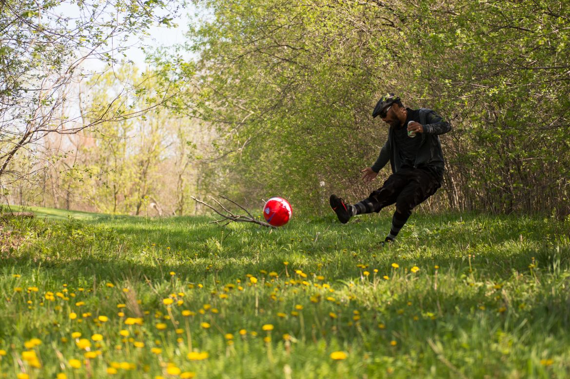 Sean Waiwaiole kicks his ball out of the rough on the 12th hole of the first ever FootGolf tournament, held at the Fox Hills Golf Course in Salem Township, Michigan, on Saturday, May 10.