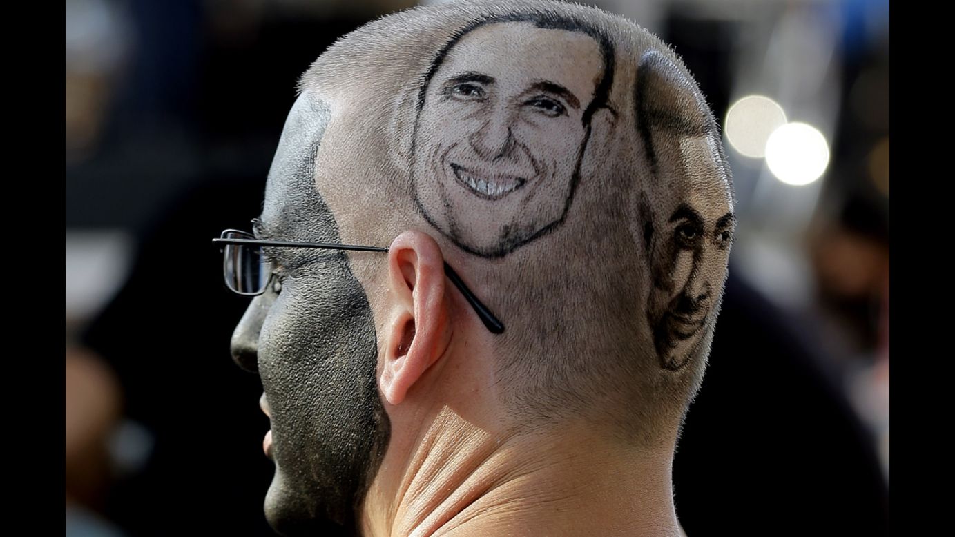 San Antonio Spurs fan Paul Fisher waits for the start of Game 2 of the NBA playoff series between the Spurs and the Portland Trail Blazers in San Antonio on Thursday, May 8. His head is marked with the likenesses of Spurs players Manu Ginobili and Tony Parker.
