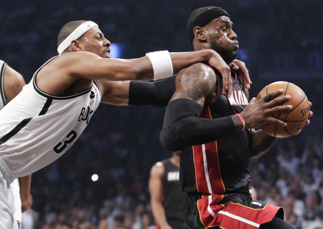 Brooklyn Nets forward Paul Pierce grabs Miami Heat forward LeBron James during Game 3 of the semifinal playoff series in New York on Saturday, May 10. Pierce was called for a flagrant foul and James scored on the play. The Nets won 104-90.