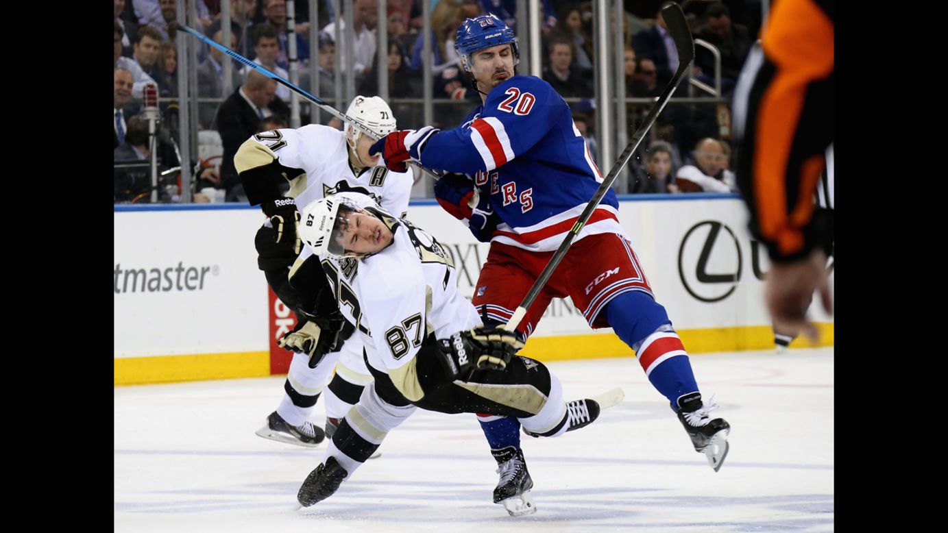 Sidney Crosby of the Pittsburgh Penguins is checked by Chris Kreider of the New York Rangers during the NHL Stanley Cup playoffs at Madison Square Garden in New York on Wednesday, May 7.