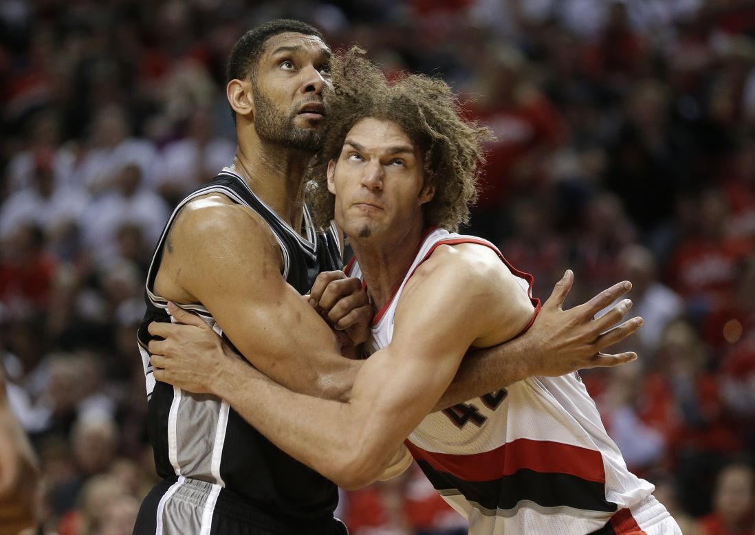 Portland Trail Blazers' Robin Lopez, right, and San Antonio Spurs' Tim Duncan battle under the boards during Game 3 of a conference semifinal playoff series in Portland, Oregon, on Saturday, May 10.