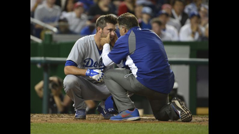 Los Angeles Dodgers catcher Drew Butera is examined by director of medical services Stan Conte after being hit in the face by a foul ball during the seventh inning against the Washington Nationals at Nationals Park in Washington on Tuesday, May 6. The Dodgers won the game 8-3. <a href="index.php?page=&url=http%3A%2F%2Fwww.cnn.com%2F2014%2F05%2F06%2Fworldsport%2Fgallery%2Fwhat-a-shot-0506%2Findex.html">See 41 amazing sports photos from last week</a>