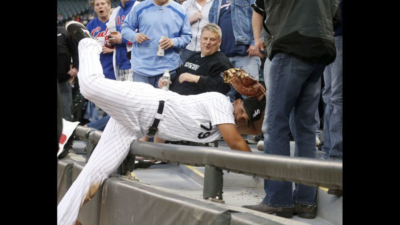 Chicago White Sox first baseman Jose Abreu shows his glove to the first base umpire after catching a fly ball off the bat of Darwin Barney of the Chicago Cubs at U.S. Cellular Field in Chicago on Wednesday, May 7.