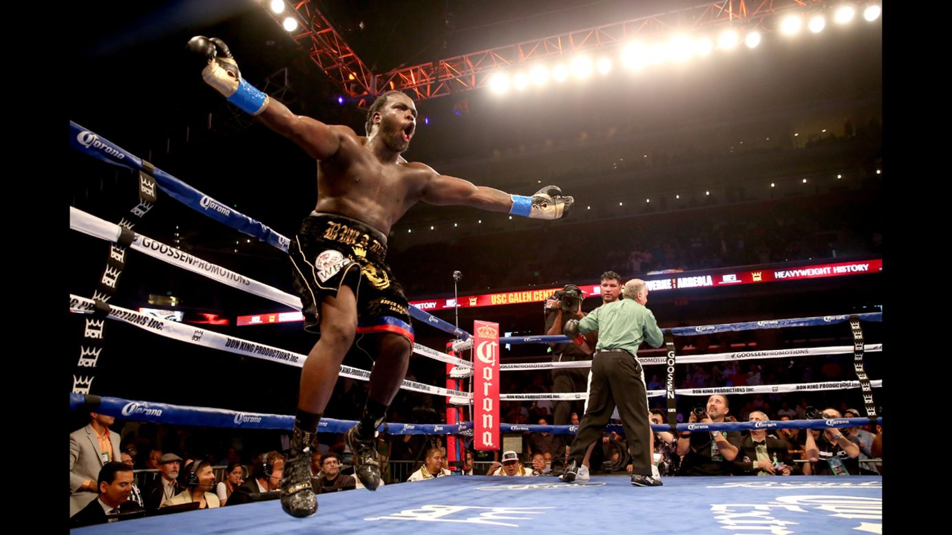Bermane Stiverne celebrates as the referee holds Chris Arreola after stopping the WBC heavyweight championship match at Galen Center in Los Angeles on Saturday, May 10. Stiverne won in a six-round technical knockout