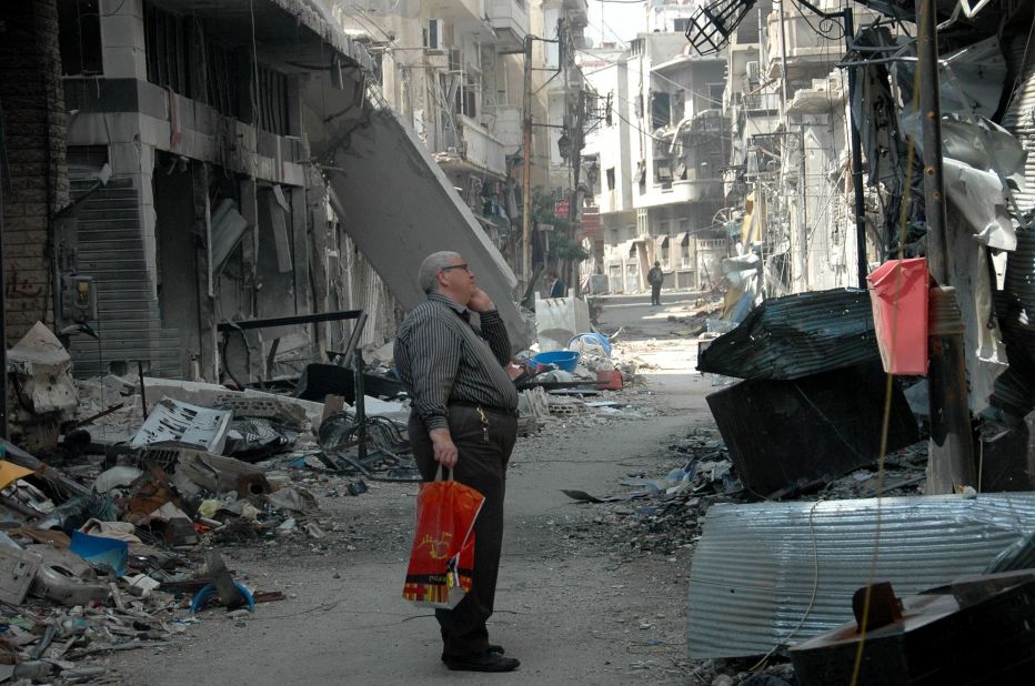 A resident surveys a damaged building in the Hamidiyeh neighborhood on May 9.
