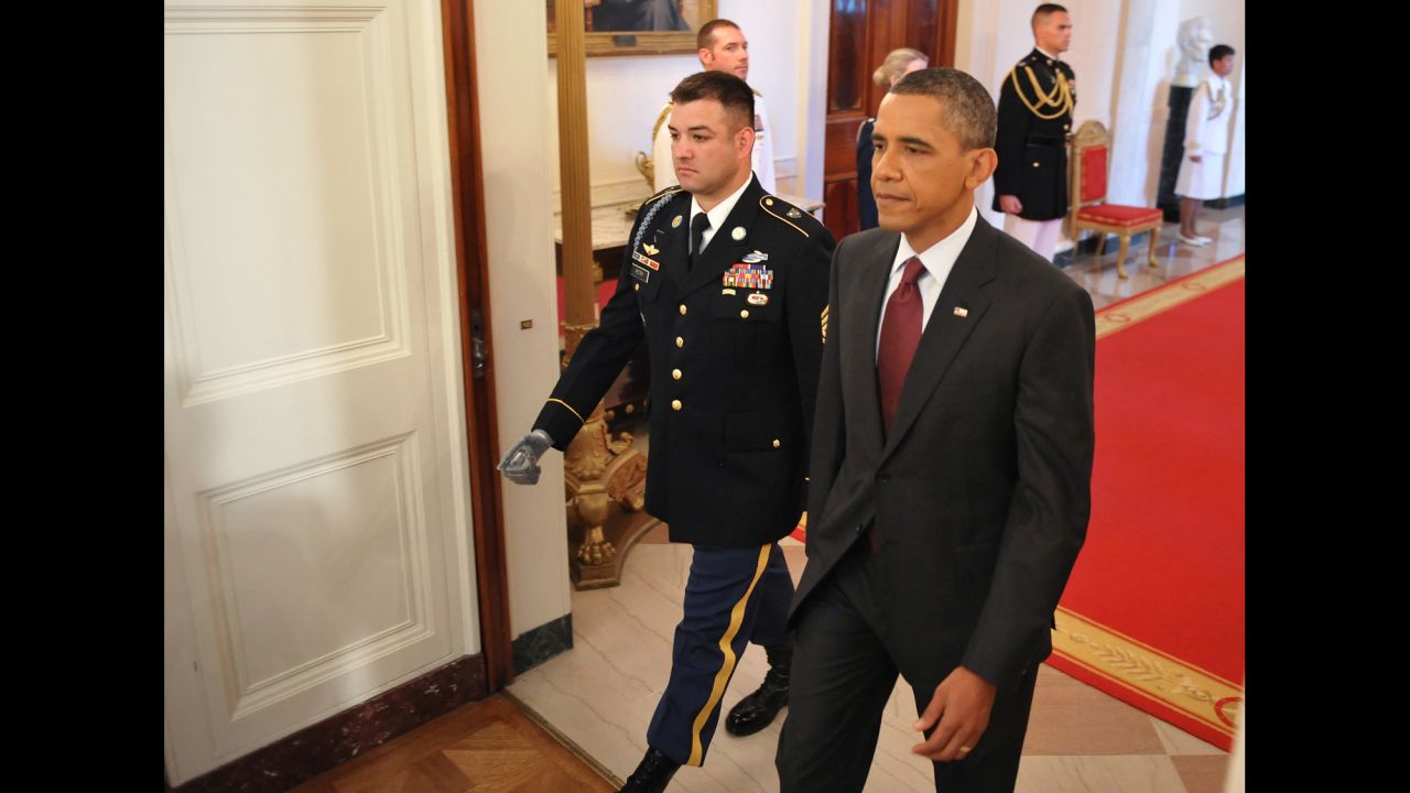 Obama walks with Army Sgt. 1st Class Leroy Arthur Petry, who received the Medal of Honor in July 2011. Petry was cited for his actions during a battle in Paktya province, Afghanistan, on May 26, 2008, which included picking up an enemy grenade thrown at him and fellow soldiers. As he was about to throw it away, the grenade exploded and blew off his right hand, according to his citation.