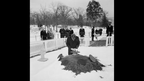 Sen. Robert Kennedy kneels by the eternal flame at the grave of his brother, President John F. Kennedy, in Arlington National Cemetery in January 1965.