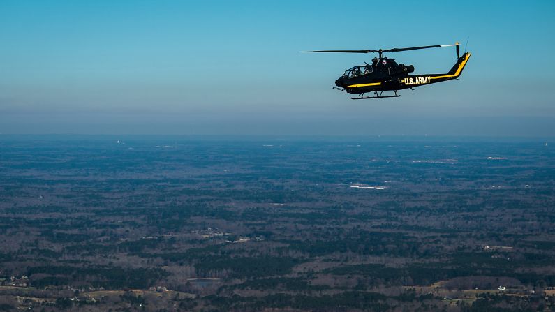 A retired Cobra AH-1 Army helicopter flies between the Henry County Airport and the Columbus Airport near Atlanta on the way to an air show in Columbus. 