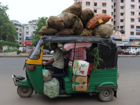 This driver wastes no space in stacking his auto rickshaw with sacks of vegetables in Ahmedabad, India.
