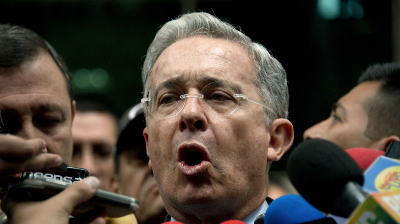 Former Colombian President (2002-2010) Alvaro Uribe speaks to the press as he leaves the public prosecutor's office in Bogota, Colombia, on May 13, 2014. Uribe challenged the public prosecutor's office, which had summoned him to formalize an accusation he made last week in which he accused close aides of President Juan Manuel Santos of pouring money received by drug traffickers into the presidential campaign for the 2010 election, and announced he will remit the case to an organ of control. AFP PHOTO/Eitan Abramovich (Photo credit should read EITAN ABRAMOVICH/AFP/Getty Images)
