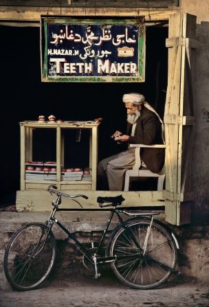 An Afghan teeth-maker sits in a makeshift shop in Kandahar, 1998.