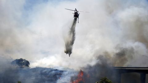 A helicopter battles a San Diego wildfire on May 13.