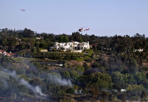 A wildfire threatens luxury homes in the Fairbanks Ranch area on May 13.