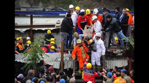 Rescue workers carry a miner to an ambulance on May 14.