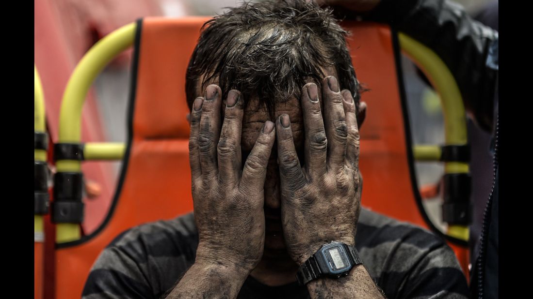 A miner covers his face after being affected by toxic gas during rescue operations on May 14.