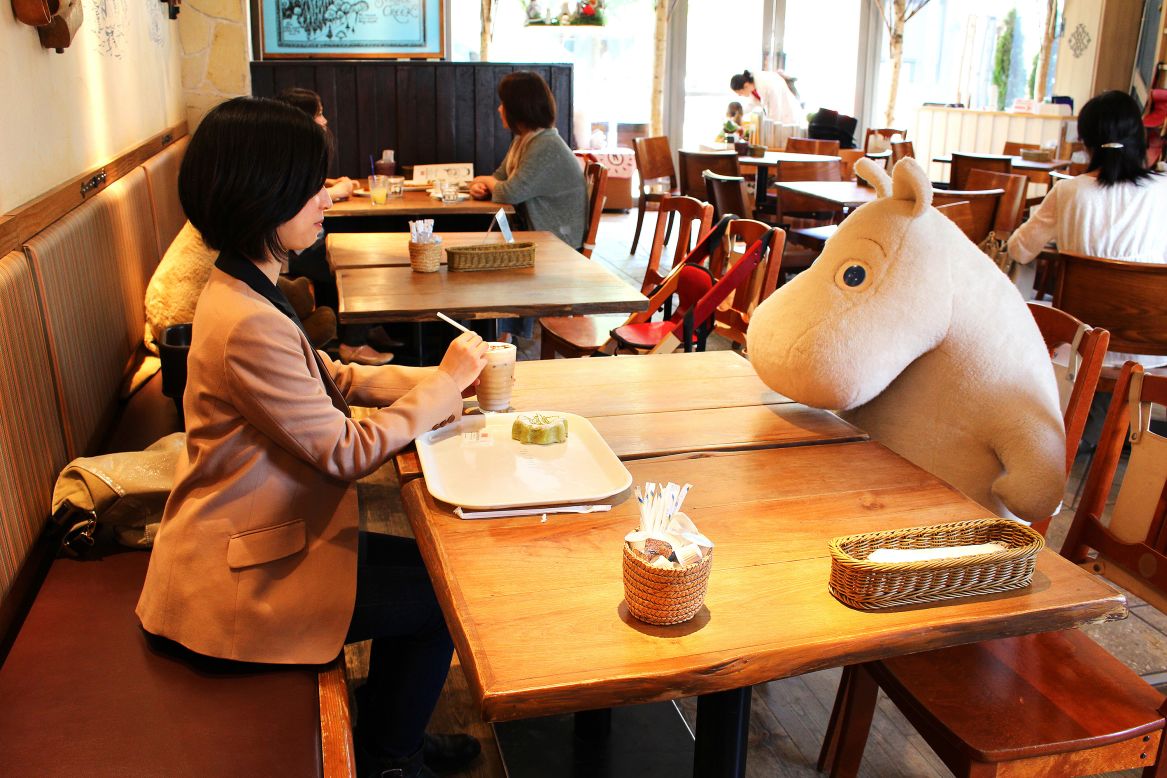At Tokyo's Moomin House Cafe, lone patrons are seated with a plush toy for company. 