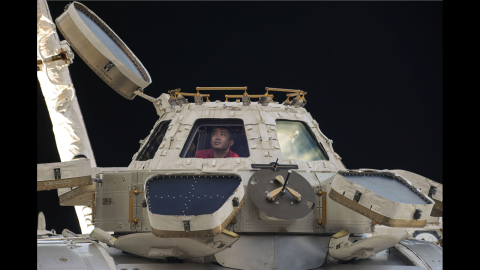 Commander Koichi Wakata of the Japan Aerospace Exploration Agency peers out of the space station's Cupola observatory on April 27. The Cupola is a dome-shaped module that allows station crew members to observe and guide activities outside the station.