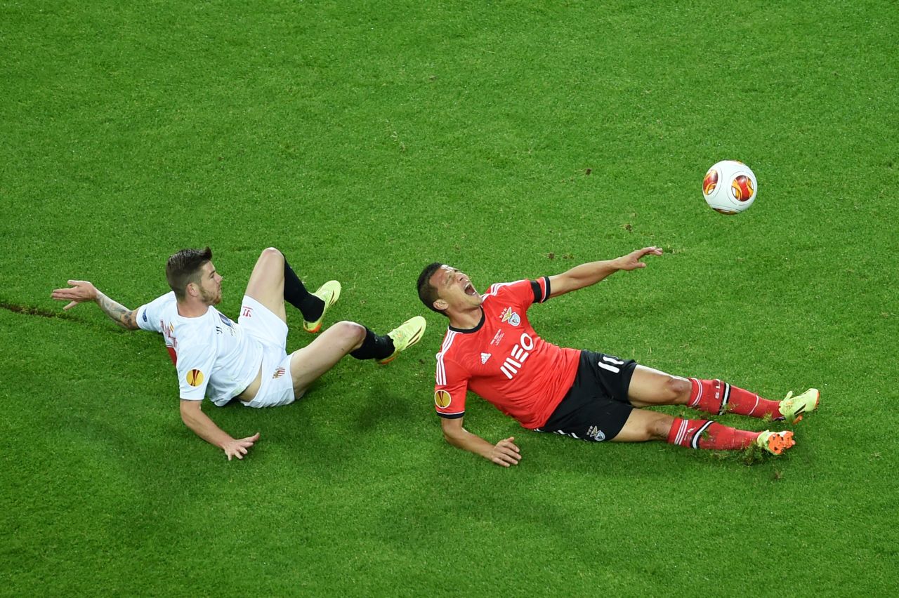 Benfica's Brazilian forward Lima (right) is brought down by Sevilla's defender Alberto Moreno inside the box on a tense night when both sides had penalty appeals turned down.