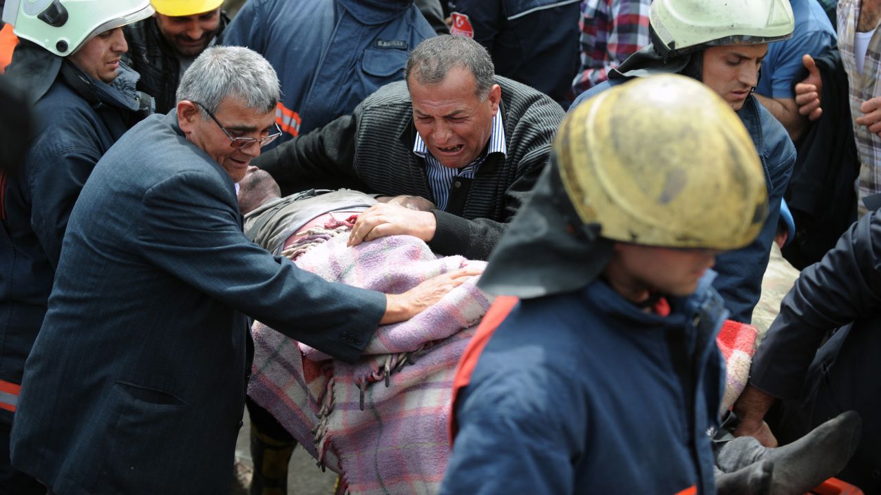 A man weeps over the body of a miner being pulled from the mine in Soma on May 14.