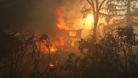 A house in San Marcos is consumed by a wildfire on May 14.