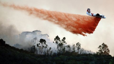 A plane drops fire retardant over a hot spot in San Marcos on May 14.