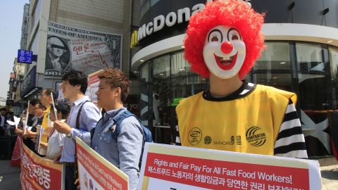 A protester dressed as Ronald McDonald participates in a strike outside a McDonald's in Seoul, South Korea.