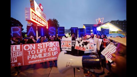 McDonald's employee Connie Ogletree, right, leads a group of fast-food workers and supporters in a chant outside a Krispy Kreme in Atlanta. 