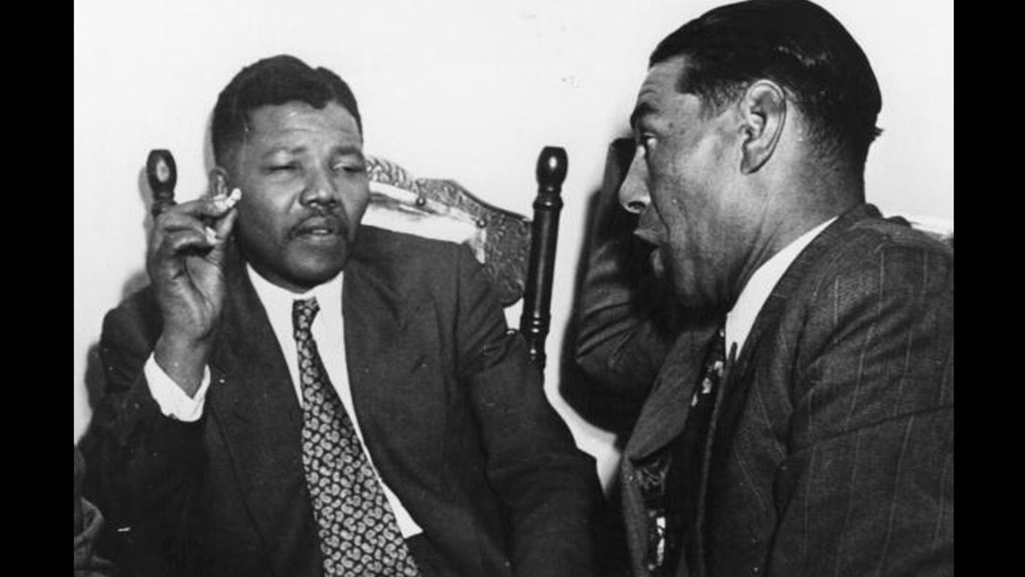 Nelson Mandela, then-president of the African National Congress, left, speaks with a teacher sometime in 1964.