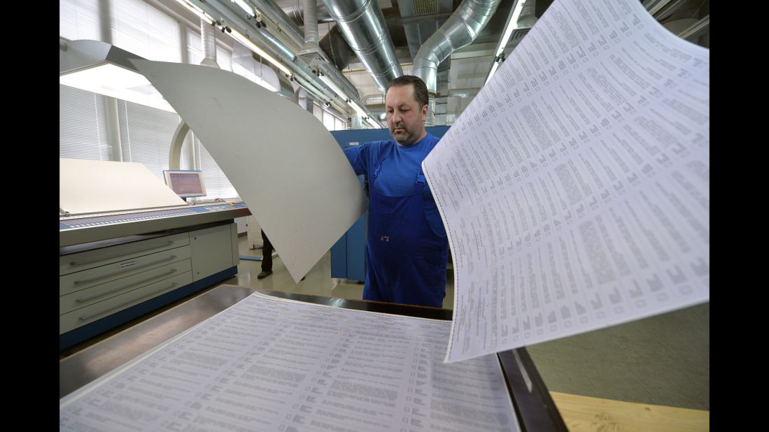 A man examines ballots at a printing house in Kiev, Ukraine, on Wedn