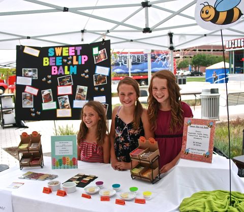 Lily Warren, right, and her two younger sisters, Chloe and Sophie, have been in the beeswax business since 2009. The Littleton, Colorado, sisters make lip balm and lotion bars using the beeswax left over from their parents' hives. They call themselves the Sweet Bee Sisters.  