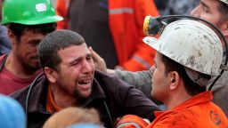 Miners react as bodies of their dead co-workers are carried out of the mine on May 14, 2014 in Soma, Turkey.