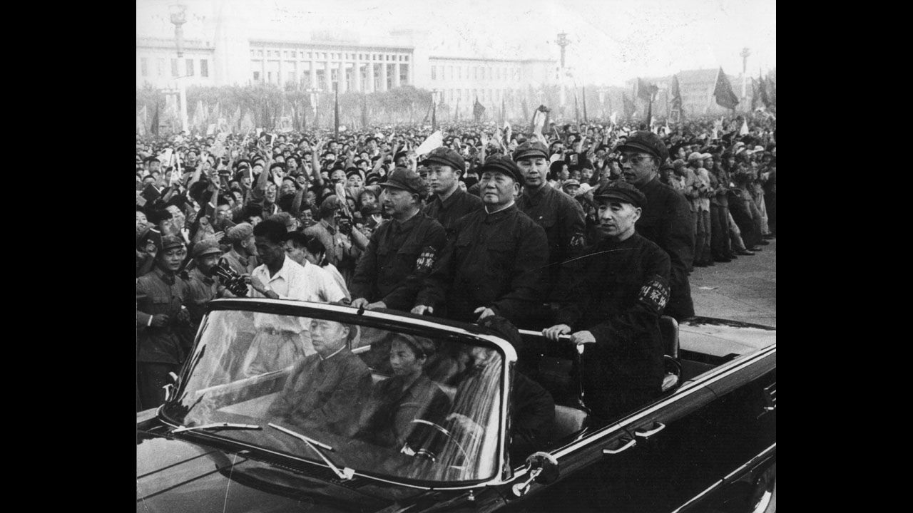 Chinese leader Mao Zedong, standing front and center, rides through a Tiananmen Square rally in Beijing in 1966. In May of that year, Mao launched the Cultural Revolution to enforce communism and get rid of old institutions and his political enemies. The political movement careened out of control and led to massive political purges, deaths and destruction before it ended in 1976.
