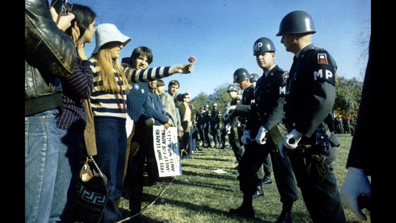 A demonstrator offers a flower to military police at the Pentagon during an anti-Vietnam protest in Washington on October 21, 1967. Marches such as this one helped turn public opinion against the war.