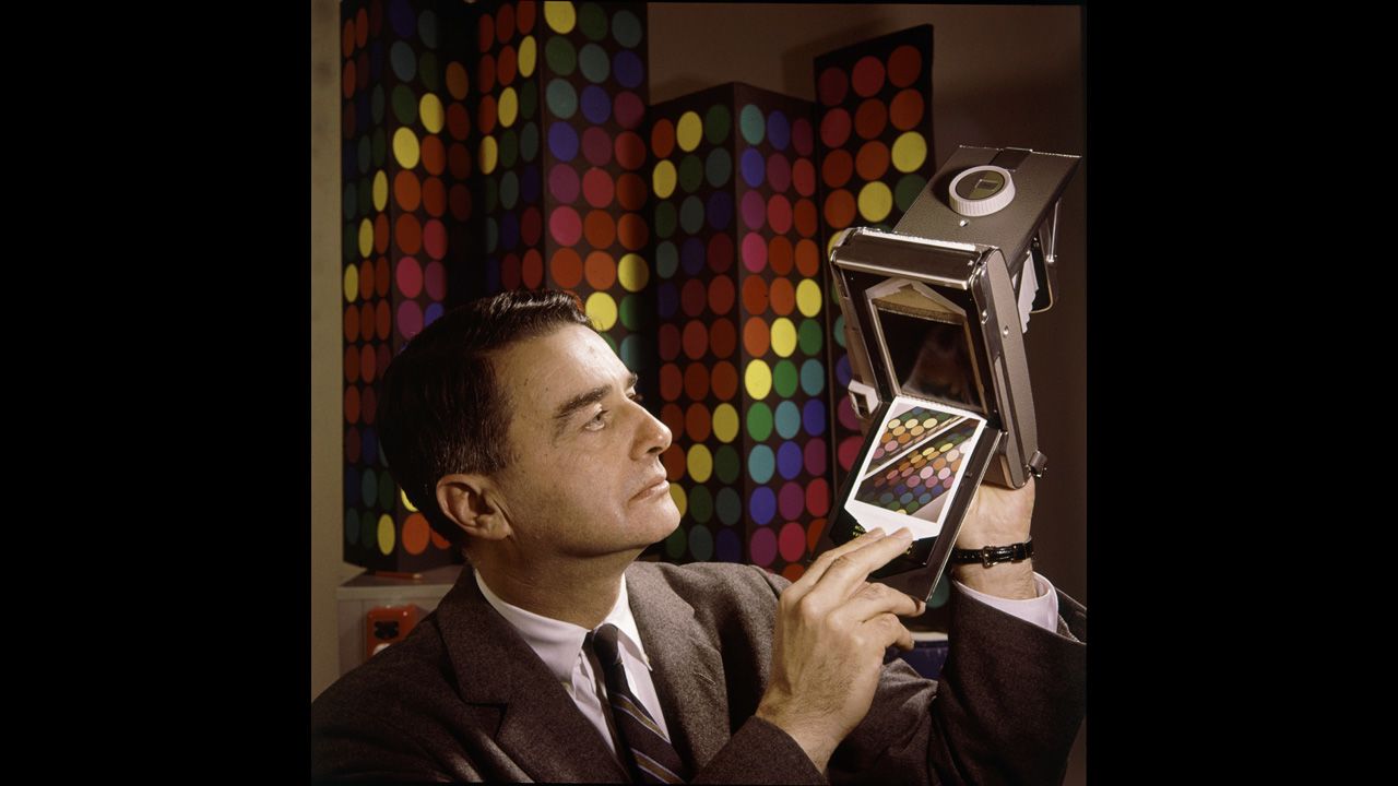 Inventor Edwin Land, president and co-founder of the Polaroid Corporation, demonstrates his company's new instant-color film in 1963.