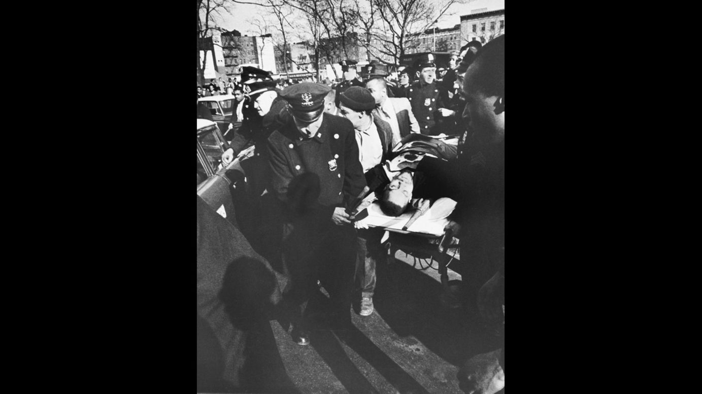 Civil rights activist Malcolm X is carried from the Audubon Ballroom in New York, where he had just been shot on February 21, 1965. He died shortly after.