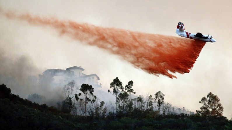 A plane drops fire retardant over a wildfire hot spot in San Marcos, California, on Wednesday, May 14. About 10,000 acres <a href="http://www.cnn.com/2014/05/13/us/gallery/california-wildfire/index.html">have already been charred</a> in San Diego County.
