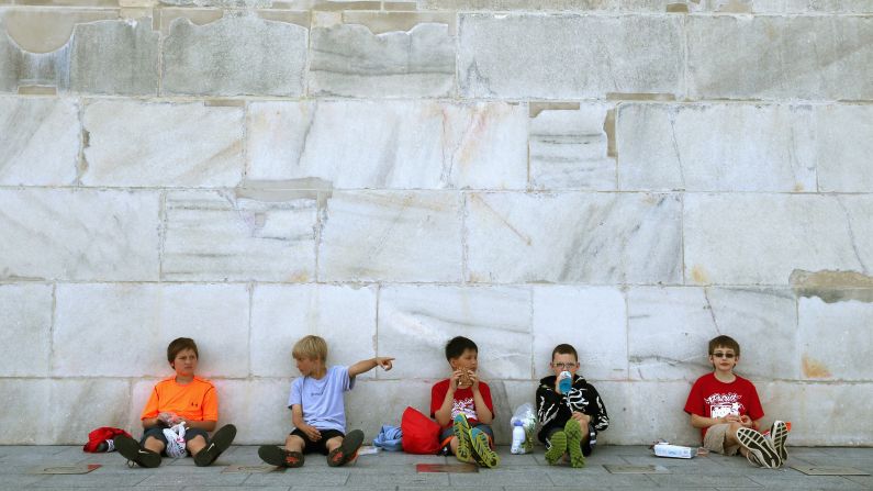 Fifth-graders have lunch in the shade of the <a href="http://www.cnn.com/2014/05/12/us/gallery/washington-monument-reopening/index.html">newly reopened Washington Monument</a> on Monday, May 12. The monument had been closed for repairs after a 2011 earthquake caused $15 million in damage.