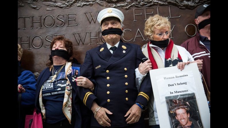 Al Santora, center, and other family members of 9/11 victims stand together on Saturday, May 10, to protest city officials' decision to keep unidentified human remains at the Memorial Museum in New York. <a href="http://politicalticker.blogs.cnn.com/2014/05/15/as-obama-visits-911-museum-a-call-to-intervene-in-dispute-over-remains/">Families who oppose the placement of the unidentified remains</a> have advocated for a separate memorial for their loved ones. They say the underground museum is prone to flooding, and they say the $24 entrance fee is inappropriate for a place akin to a cemetery.