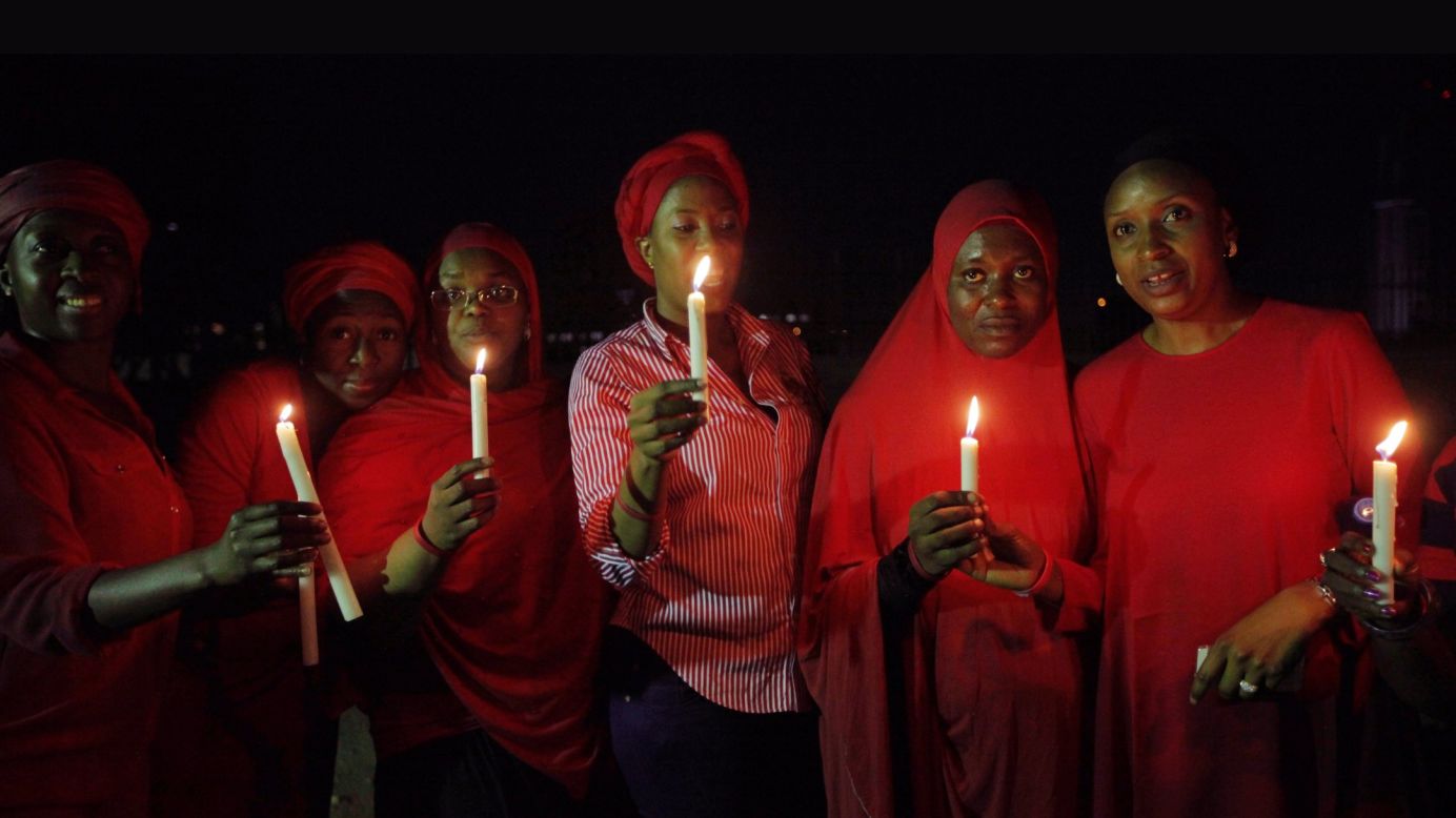 Women in Abuja hold a candlelight vigil on Wednesday, May 14, one month after the schoolgirls were kidnapped.