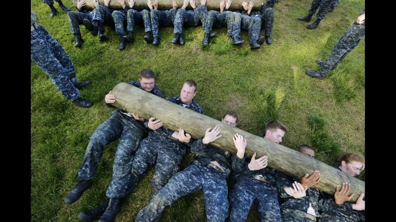Freshman midshipmen, known as "plebes," perform situps with a log across their chests during Sea Trials, a day of physical and mental challenges that caps off their first year at the U.S. Naval Academy in Annapolis, Maryland, on Tuesday, May 13.