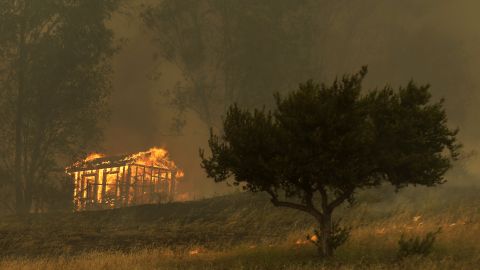 Fire engulfs a structure in Escondido, California, on Thursday, May 15.