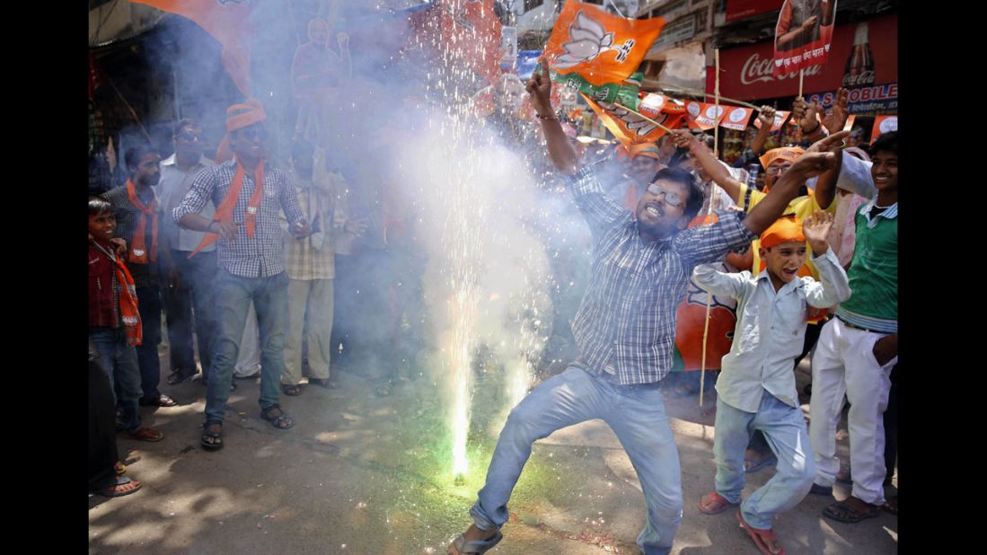 BJP supporters dance and set off firecrackers at the news of election results in Allahabad on May 16.