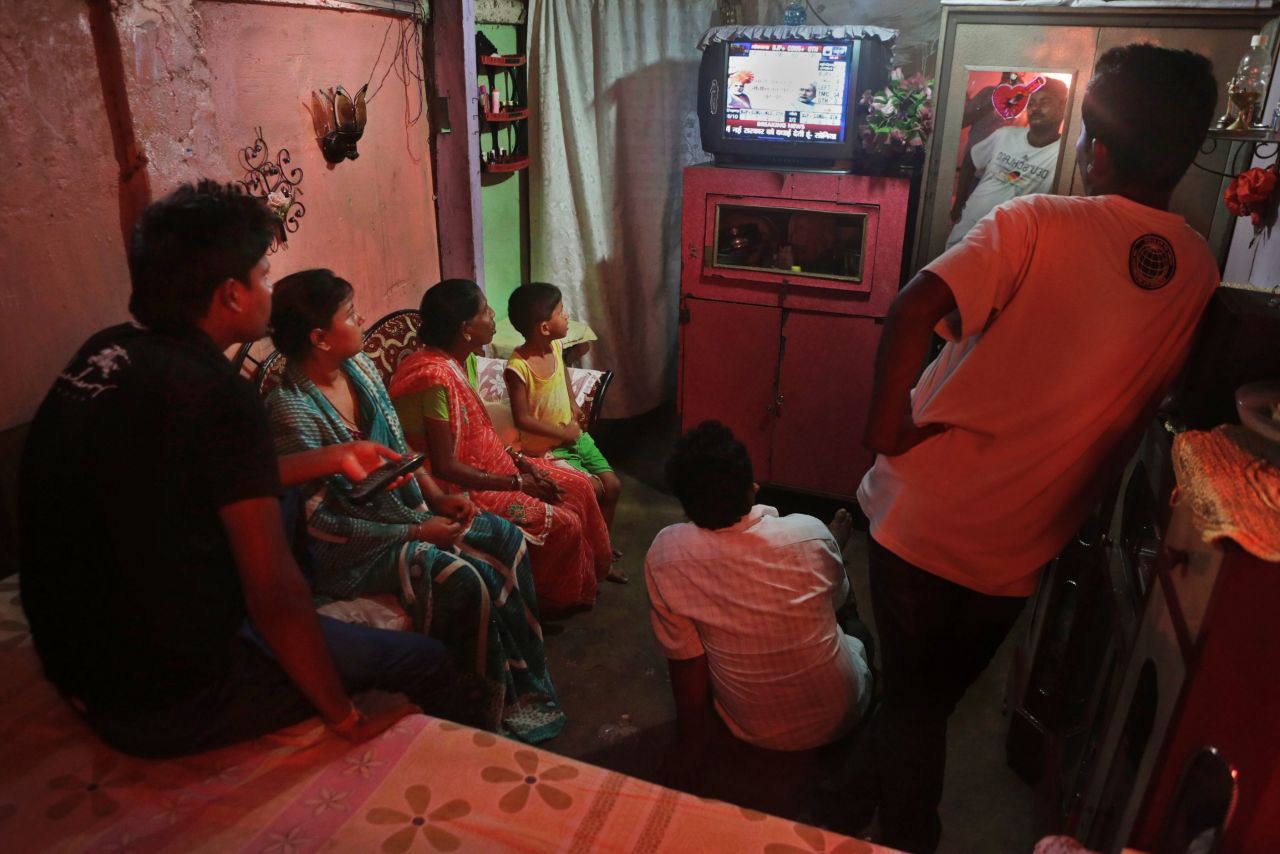 A family follows election results on TV in Guwahati on May 16. 