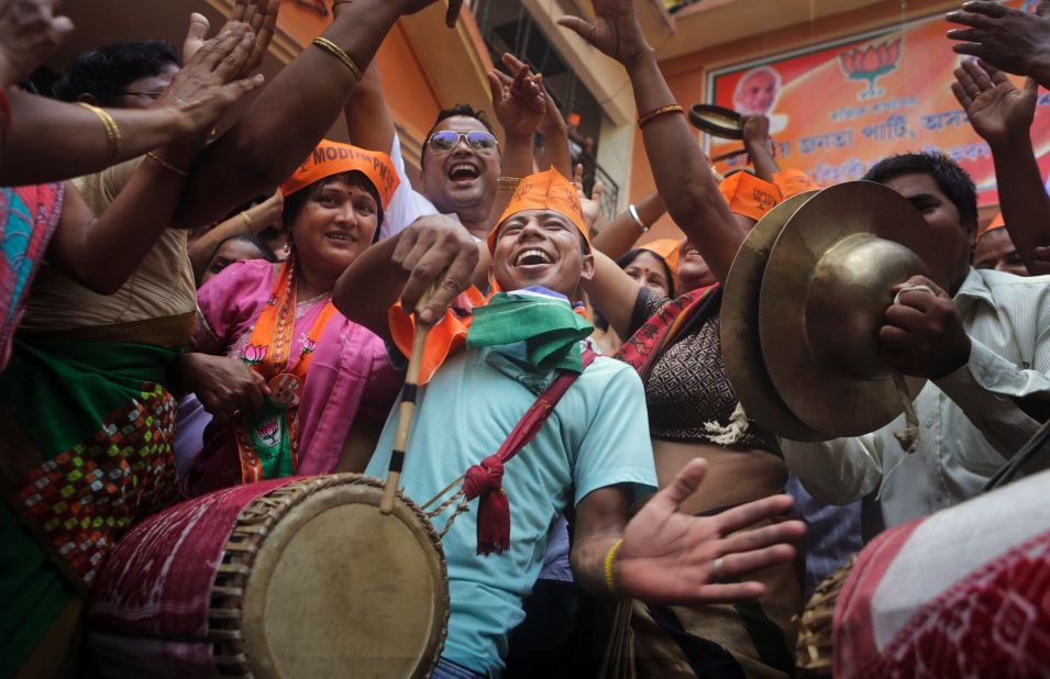 Supporters celebrate the opposition's victory in early preliminary results in Guwahati on May 16. 