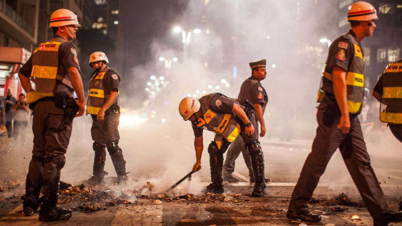 Military personnel put out a fire in a Sao Paulo street on May 15.