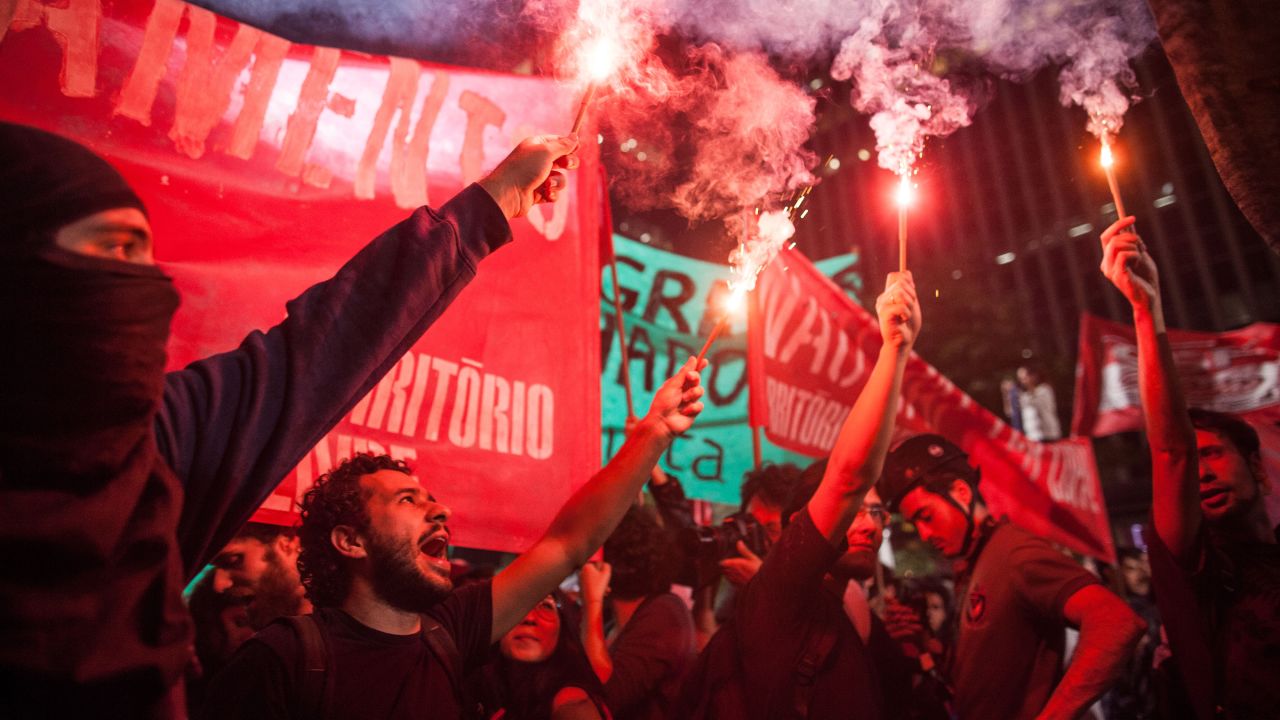 Protesters burn flares in the streets of Sao Paulo on May 15.