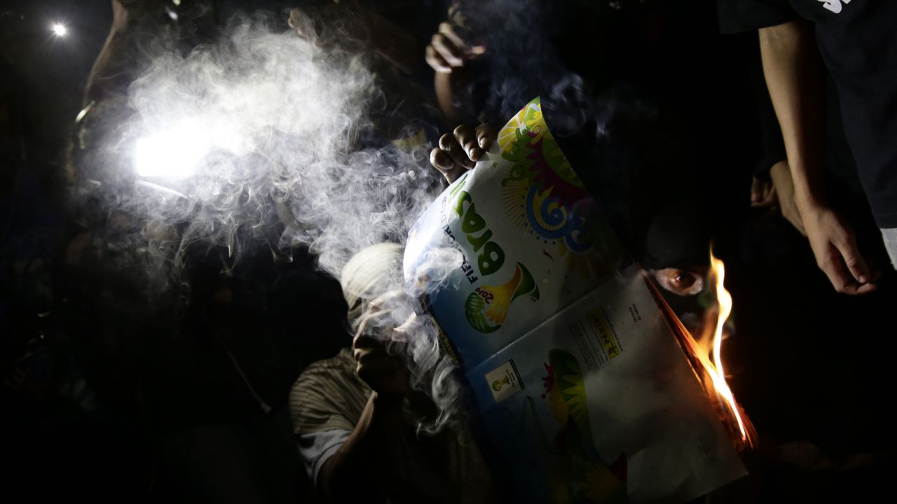 Protesters burn a World Cup magazine in Rio de Janeiro on May 15.