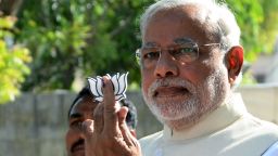 BJP party leader Narendra Modi holds up the party symbol after casting his vote at a polling station in Ahmedabad, India on April 30.