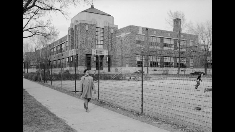 Linda Brown, 9, walks past Sumner Elementary School in Topeka, Kansas, in 1953. Her enrollment in the all-white school was blocked, leading her family to bring a lawsuit against the Topeka Board of Education. Four similar cases were combined with the Brown complaint and presented to the US Supreme Court as <a href="index.php?page=&url=http%3A%2F%2Fwww.cnn.com%2F2013%2F07%2F04%2Fus%2Fbrown-v-board-of-education%2Findex.html">Brown v. Board of Education.</a> The court's landmark ruling on the case on May 17, 1954, led to the desegregation of the US education system.